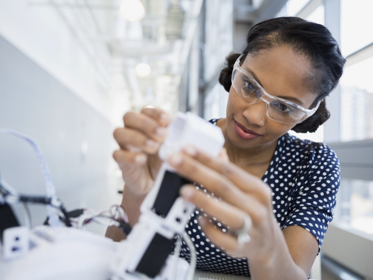 A person working on a robotic arm