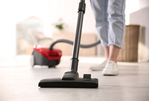 A person using a small vacuum