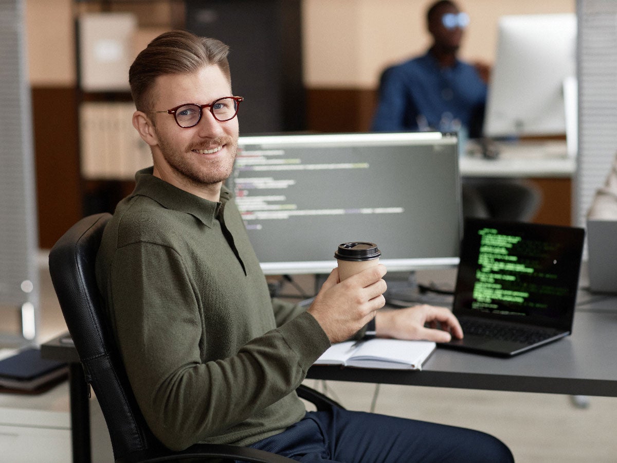 Smiling person at his work desk