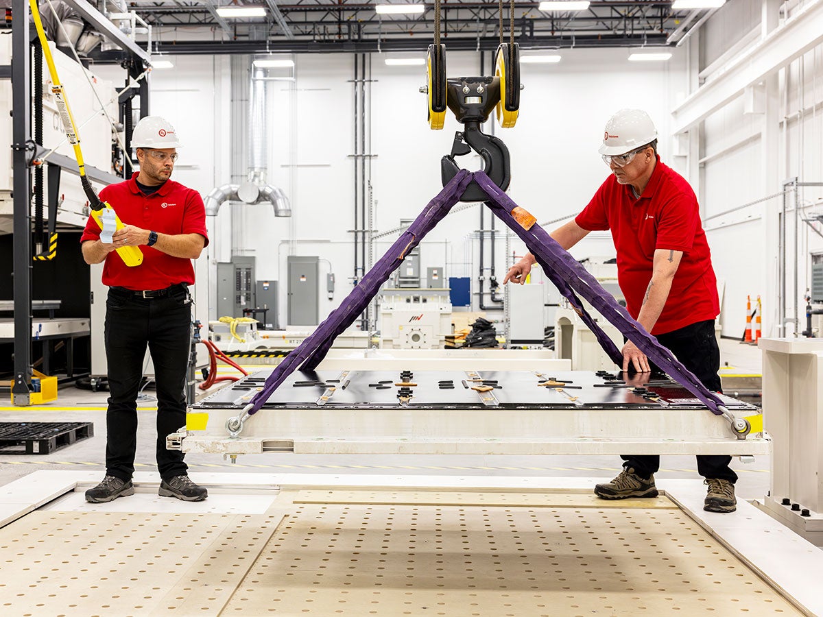 Two UL Solutions employees testing an EV battery
