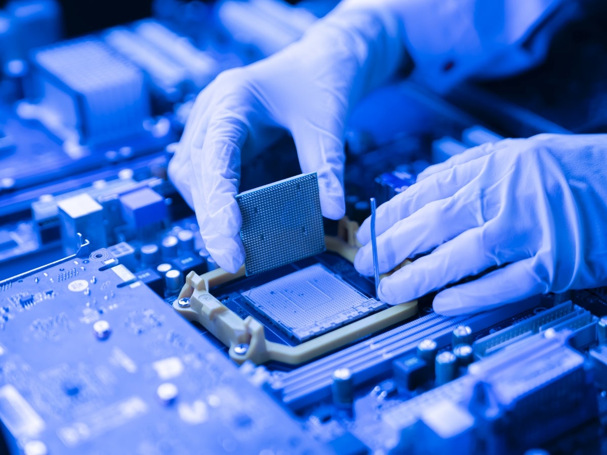 Person installing a processor into the CPU socket