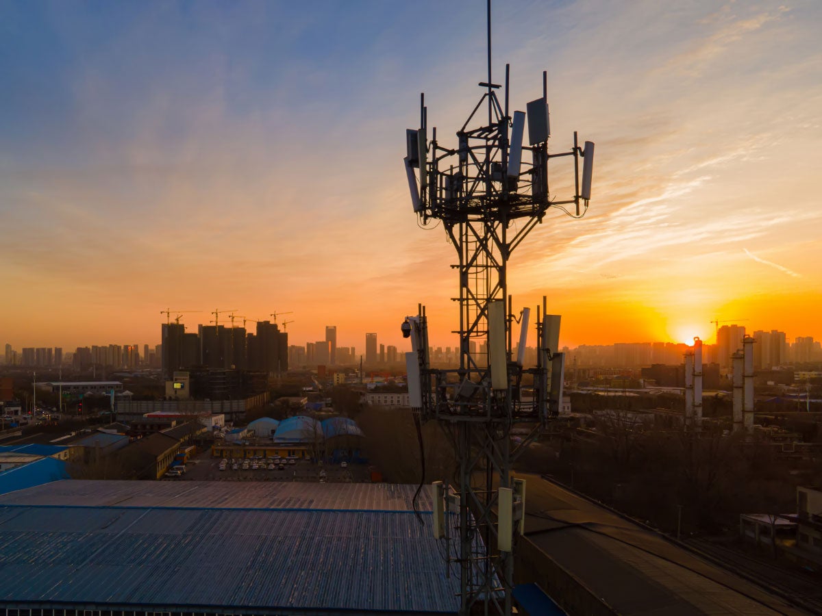 Aerial view of a 5G cellular communications tower at sunset
