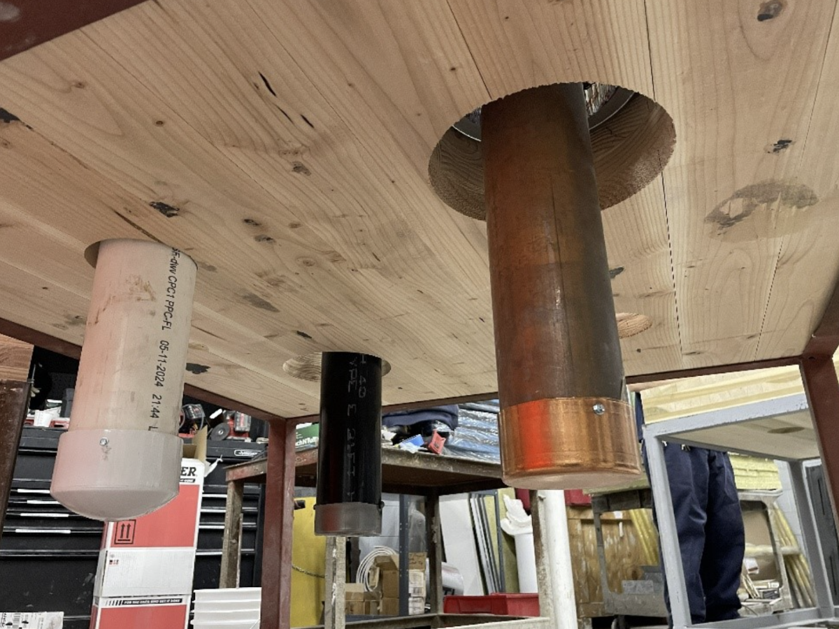 Firestop test including various penetrants in one of the CLT floor slabs