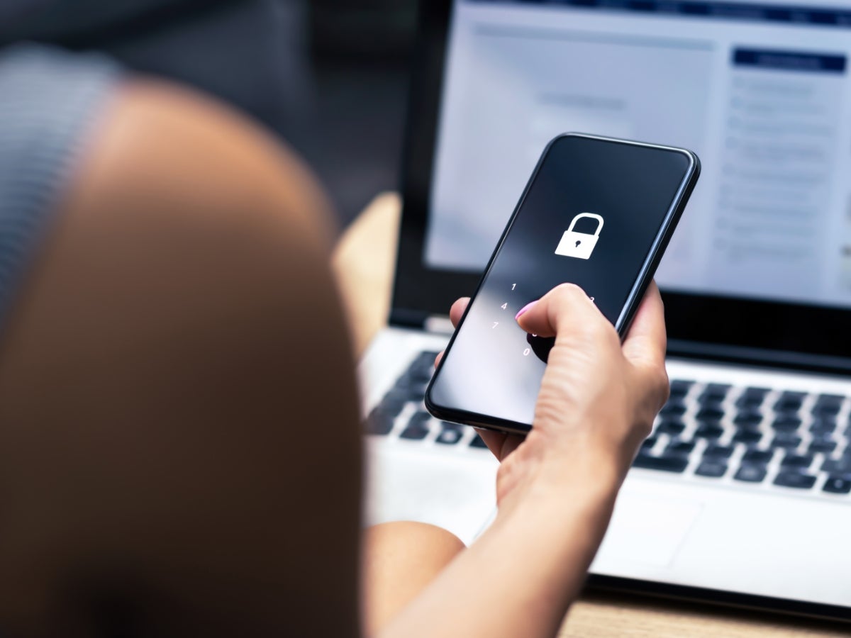 Person using two factor identification with a laptop and mobile device