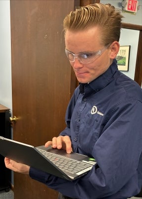 Adam Kody checks data during a visit to a manufacturer.