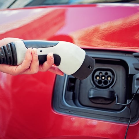 plugging in charger on electric vehicle