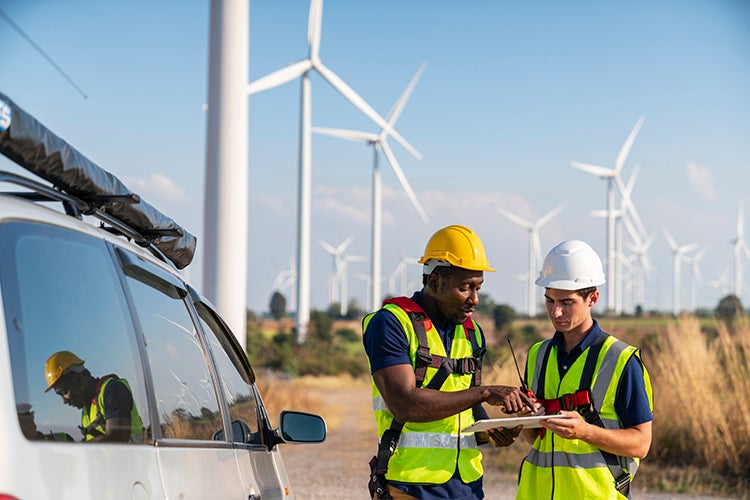 Engineers reviewing data at a wind farm