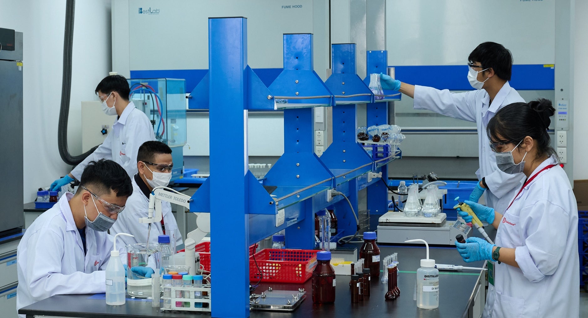 ULS workers in a testing laboratory in Vietnam