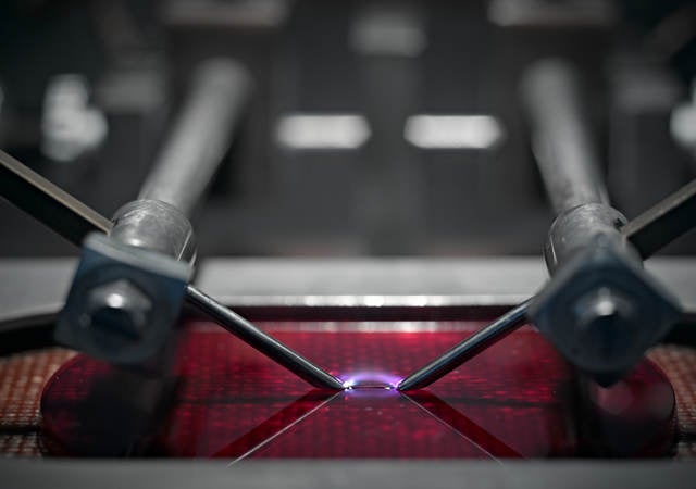A close-up picture of a machine testing plastic. 