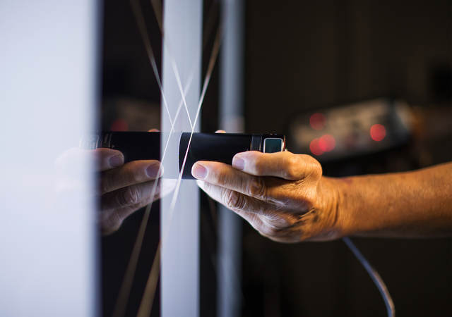 scientist takes measurement on glass