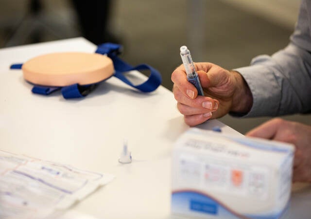 Practitioner holding injection product