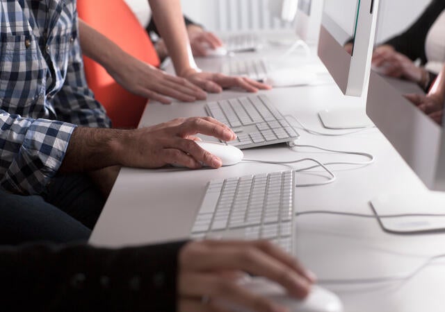 People using computers at desk