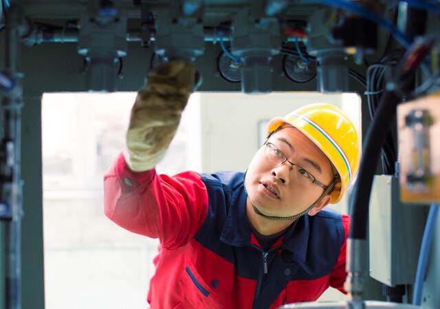 Person inspecting machinery