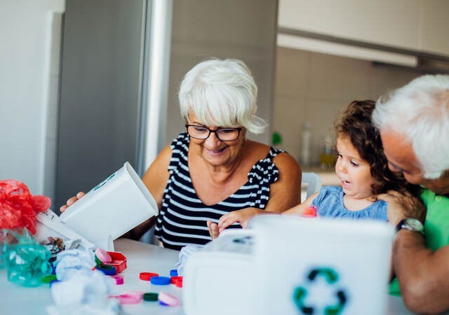 Grandparents sort recyclables with their grandchild