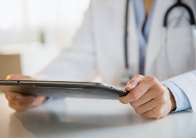 Doctor looking at a tablet