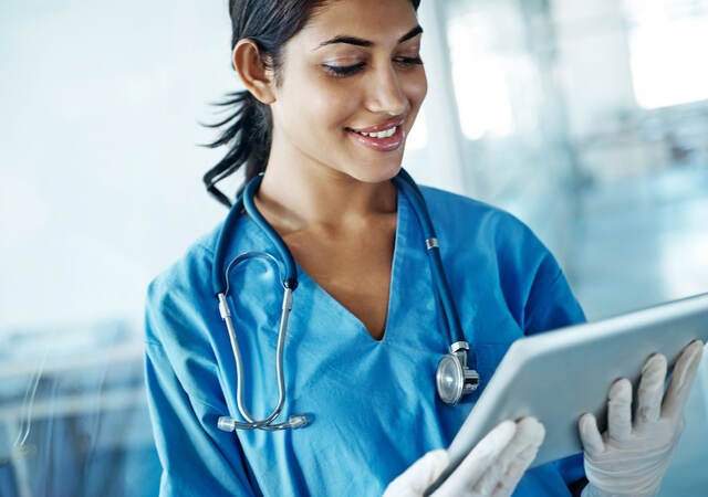 Nurse looking at a tablet