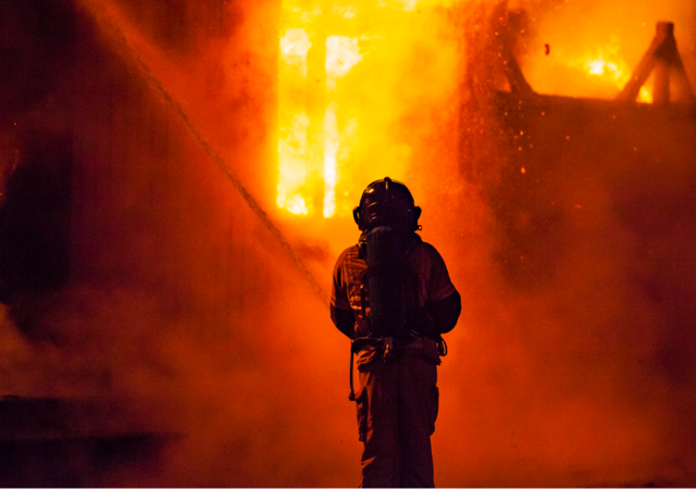 Firefighter and fire at night