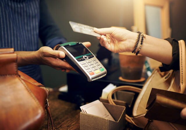 woman holding a credit card for payment