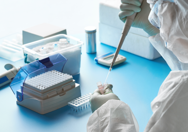 scientist adding fluid test tube