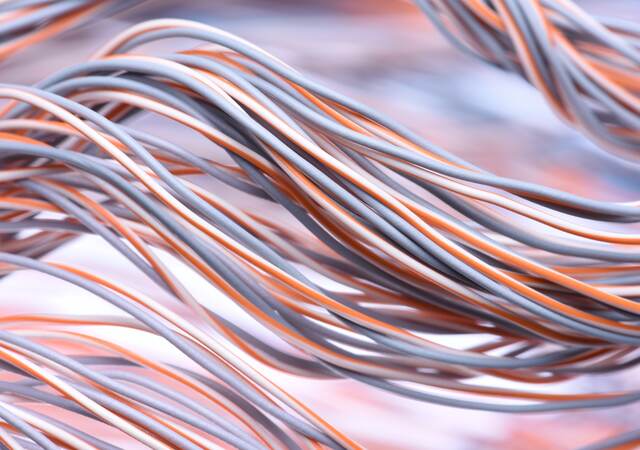 A closeup look at a swirl of electric cables and wires.