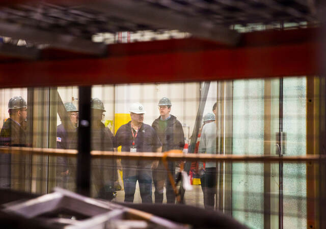 Employees discussing while standing in testing facility