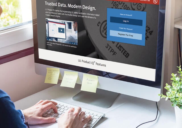 Person sitting at a desk using UL Product iQ on a computer