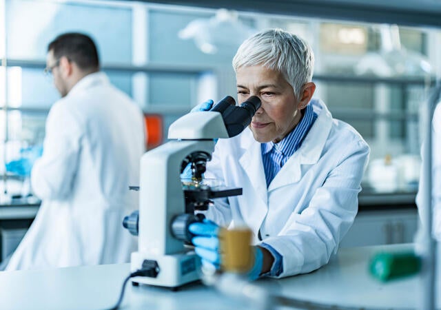 Scientist working on a microscope