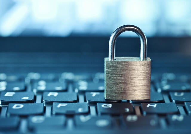 an image of a locked padlock sitting on a keyboard