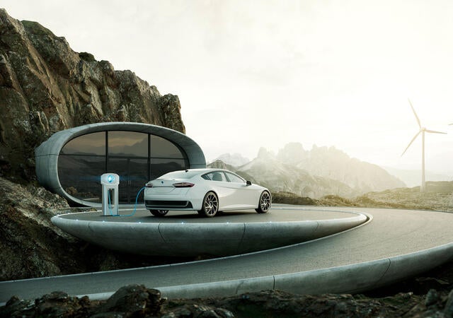 A modern home with a car charging at a charging station