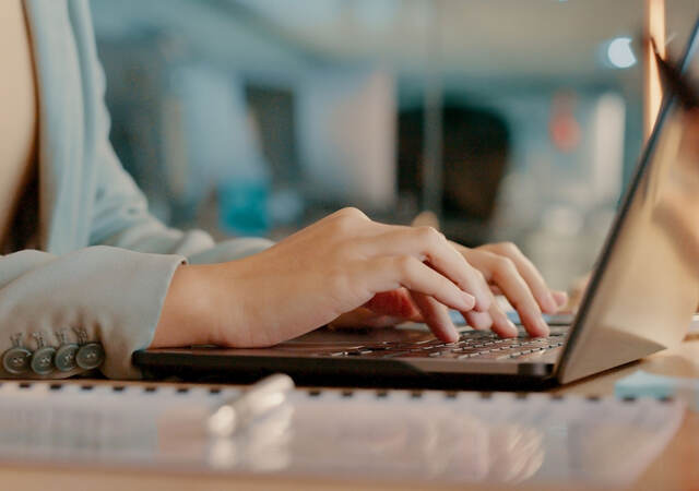 a person typing on a laptop