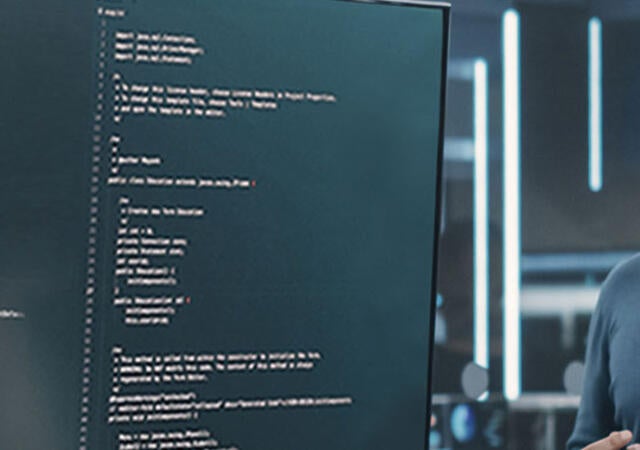 People looking at a large monitor