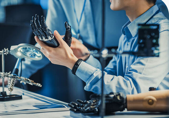 Engineer working on a robotic prosthetic arm