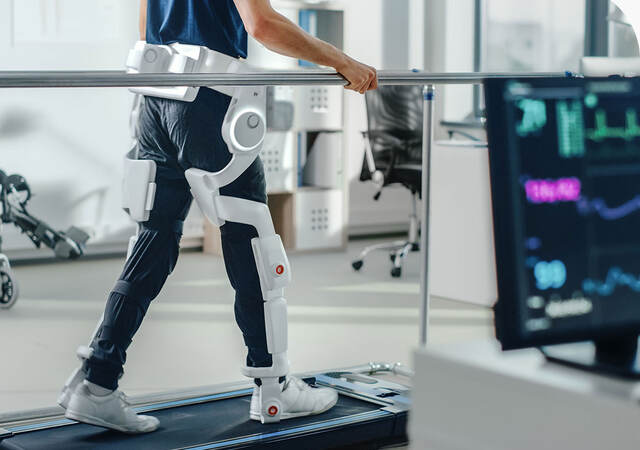 Patient with injury walks on a treadmill while wearing advanced robotic exoskeleton legs
