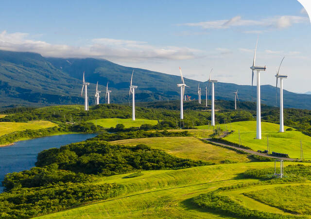 Wind turbines across a green valley