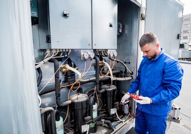 A technician working on a cooling unit