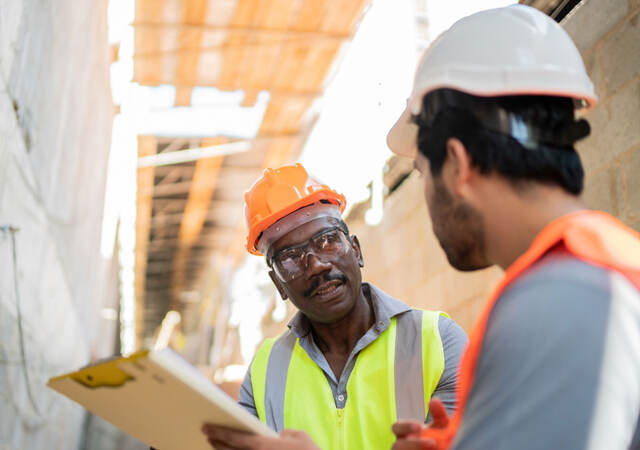 Two construction workers talking