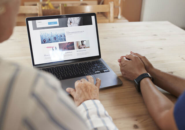 two people navigating a web page