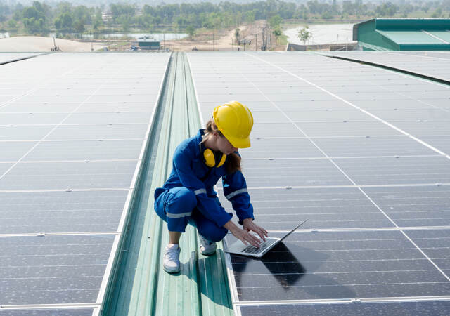 person working on solar panels