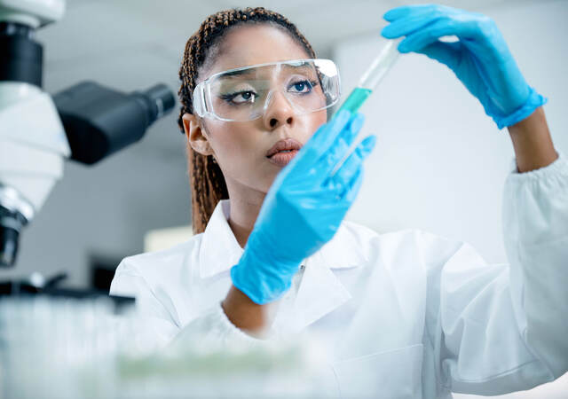 Medical researcher analyzing a sample while meeting GMP requirements in clinical studies