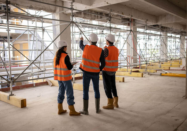 Three construction engineers inspecting work