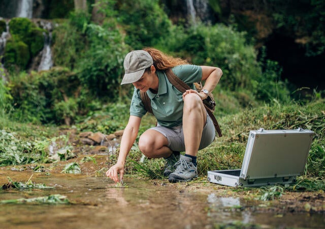 Biological Researcher Taking a Water Sample