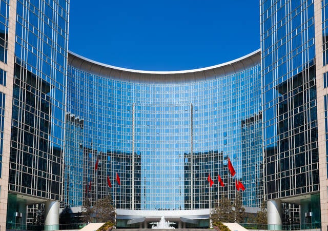 A beautiful glass building with blue sky in the background