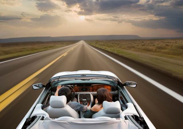 A white convertible on a highway