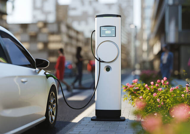 An electric vehicle charging at a charging station