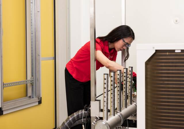 A person working in the HVAC Performance Carugate laboratory