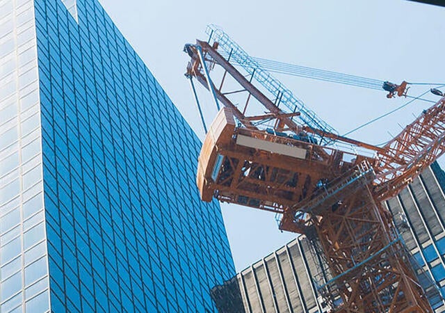 Building being constructed using a large crane