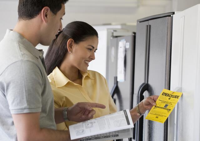Couple shopping for refrigerator