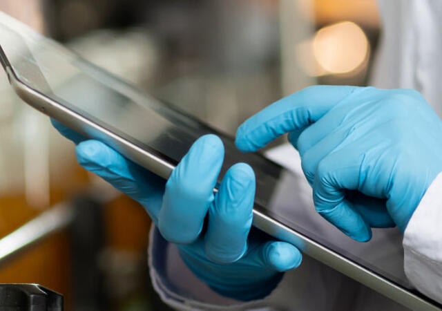 Quality control worker analyzing products on a production line