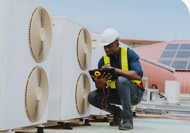 Engineer checking the air conditioning and cooling system in a commercial building.