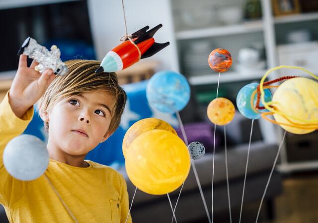 A child playing with a constellation toy